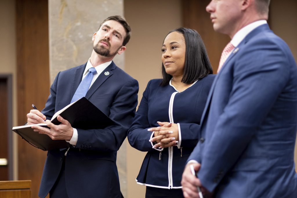Fulton County District Attorney Fani Willis (center) and members of her team watch as potential jurors are excused during May 2022 proceedings in Fulton County, Georgia, to look into the actions of former President Donald Trump and his supporters who tried to overturn the results of the 2020 election.