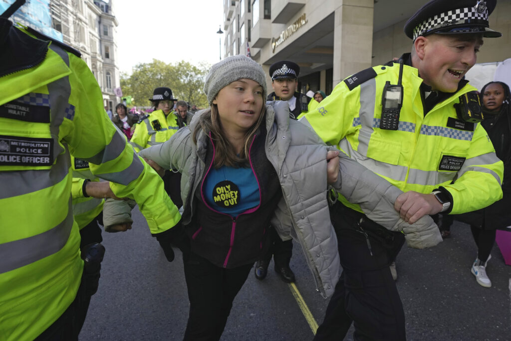 Environmental activist Greta Thunberg is taken away by police officers during the Oily Money Out protest outside the Intercontinental Hostel in London on Tuesday, Oct. 17, 2023. 