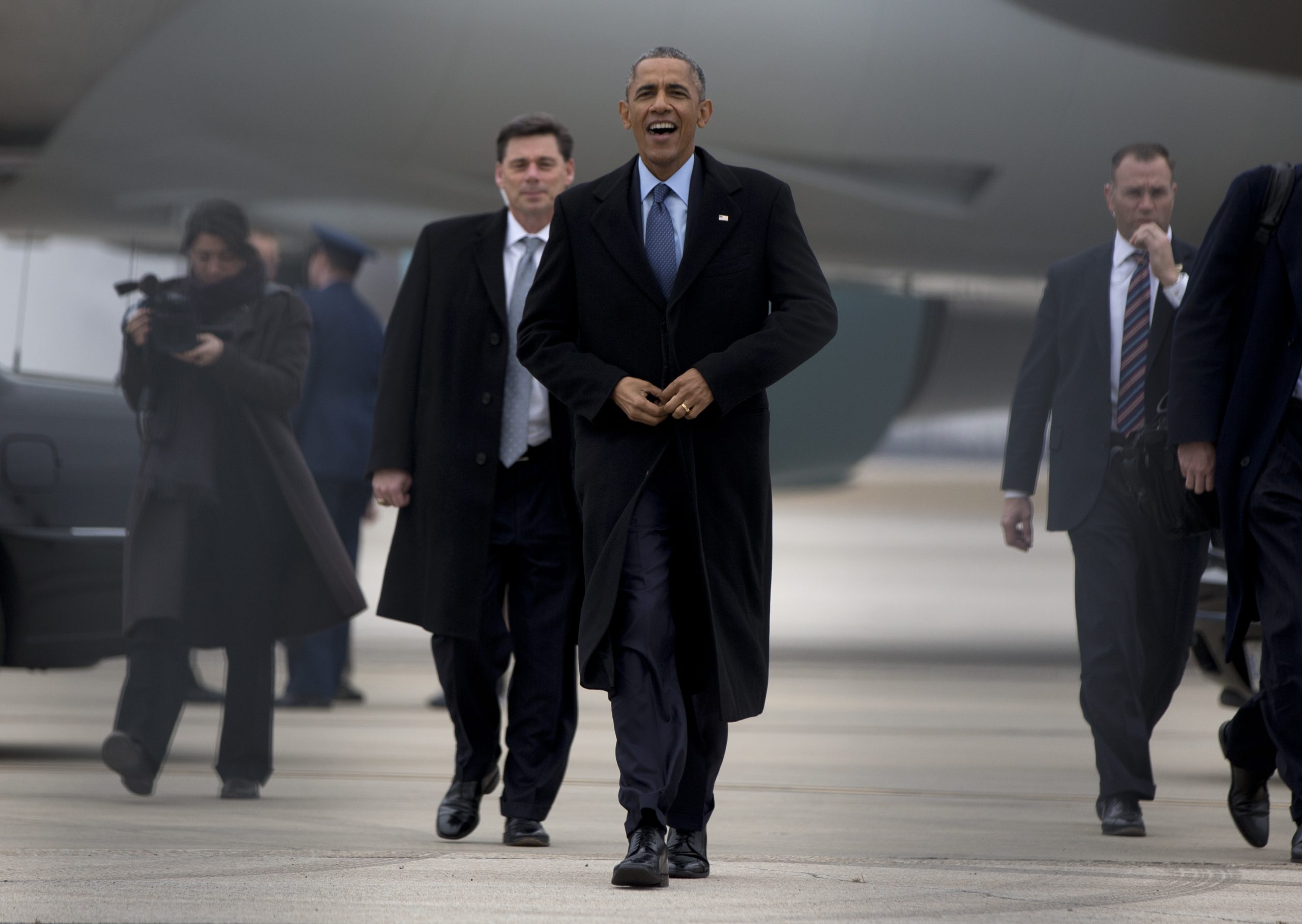 President Barack Obama walks to greets people on the tarmac before boarding Air Force One at Forbes Field Airport, Thursday, Jan. 22, 2015, in Topeka, Kansas, en route to Washington, after speaking at the University of Kansas in Lawrence, Kan., about the themes in his State of the Union address. (AP Photo/Carolyn Kaster)