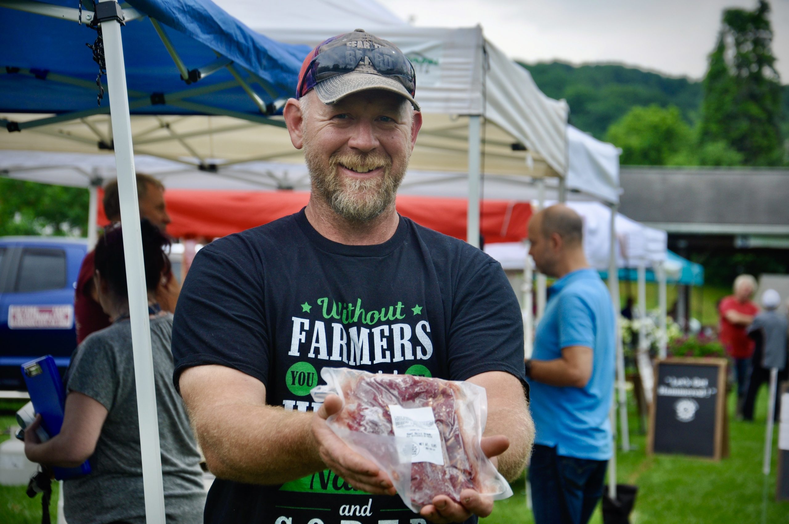 Farmer Mike Little of Chaganra Farms in Unity Township Pennsylvania, the fourth generation farmer is holding one of the pork chops he was selling at local farmers market; for the past ten years farm to table retail has grown in this countr.jpeg
