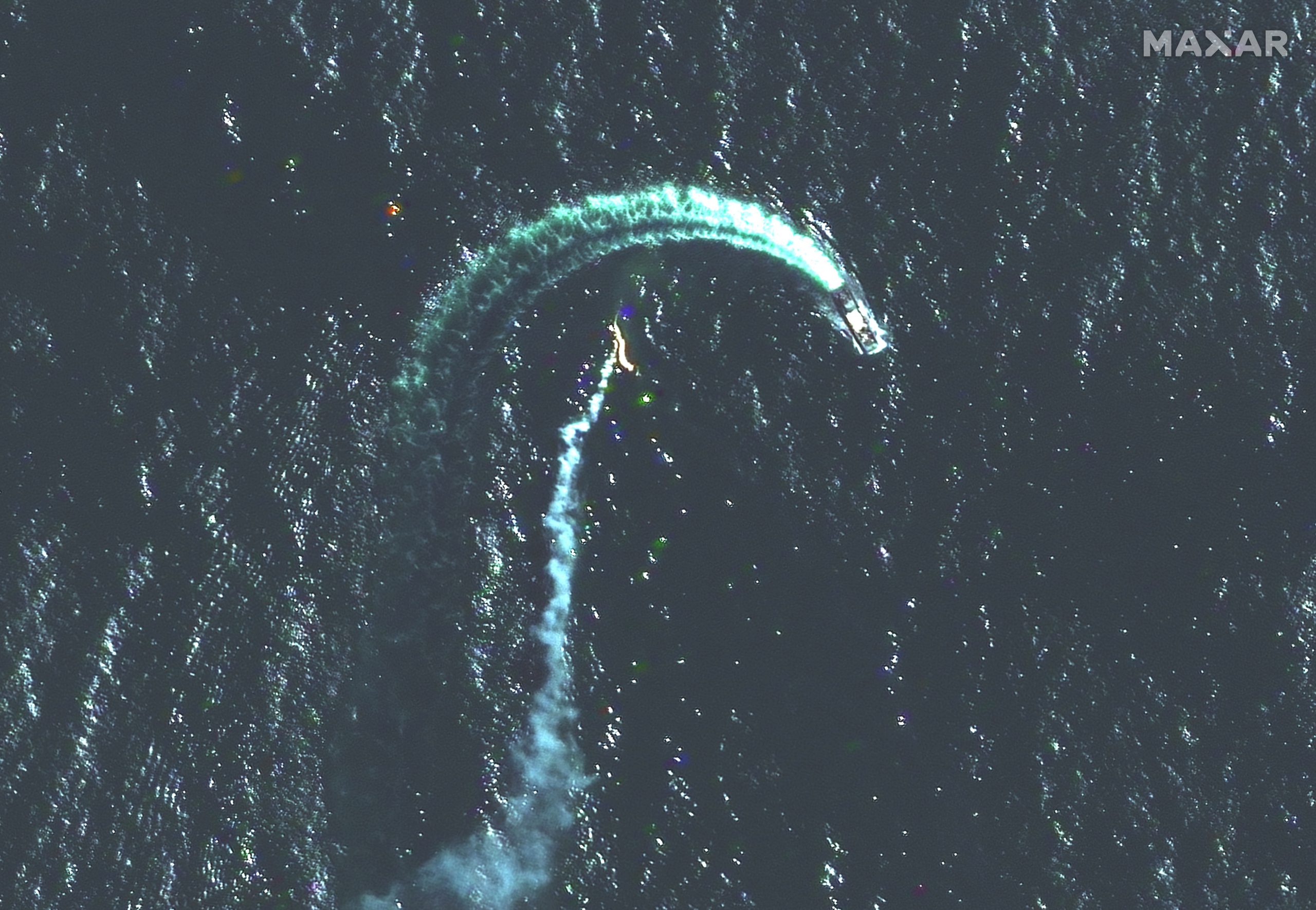 A Russian Serna-class landing ship and a possible missile contrail are seen in the water.