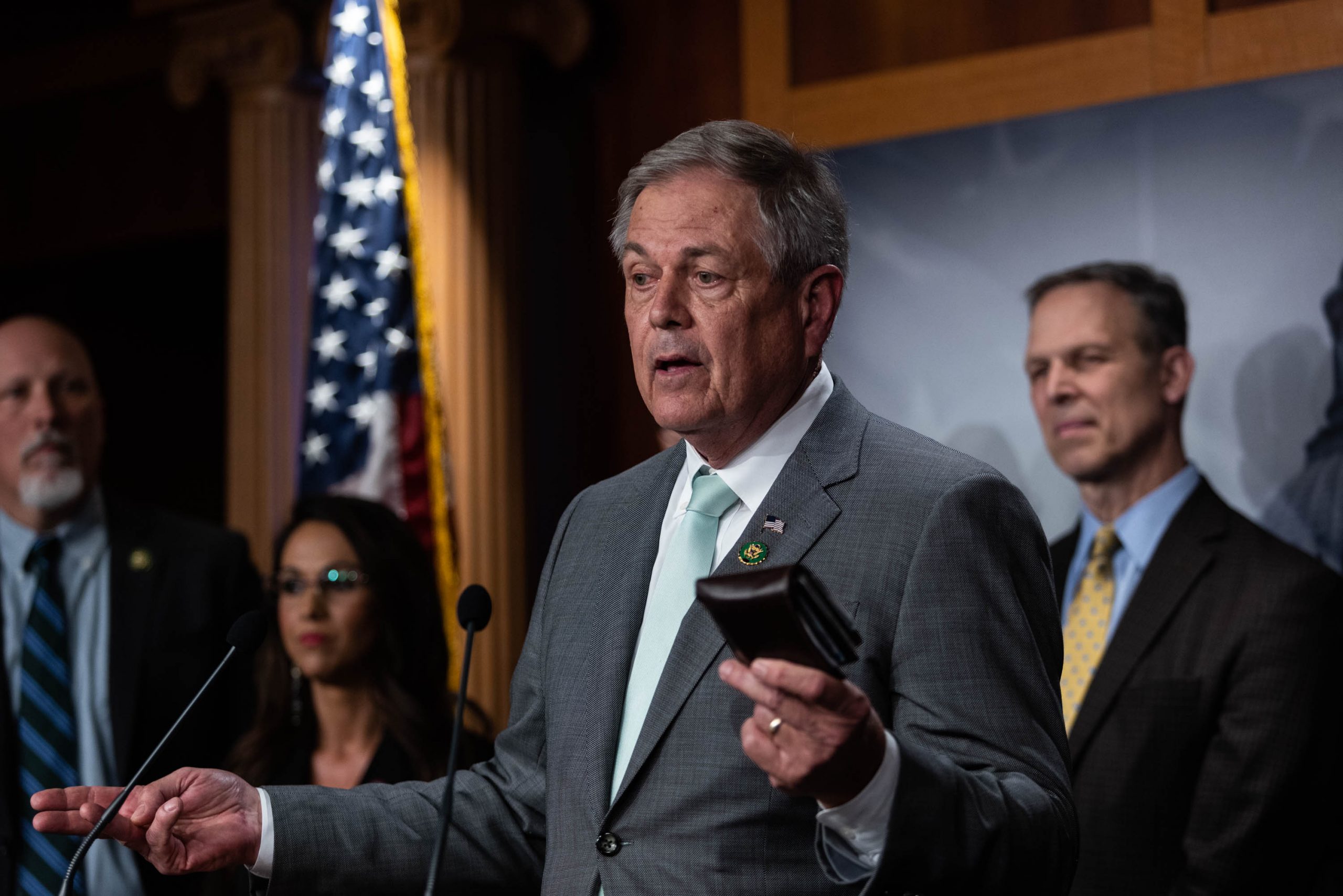 Rep. Ralph Norman (R-SC) holds his wallet while speaking at a news conference with senators and members of the House Freedom Caucus on the debt limit and spending reforms in the Senate studio of the U.S. Capitol on Wednesday, March 22, 2023.