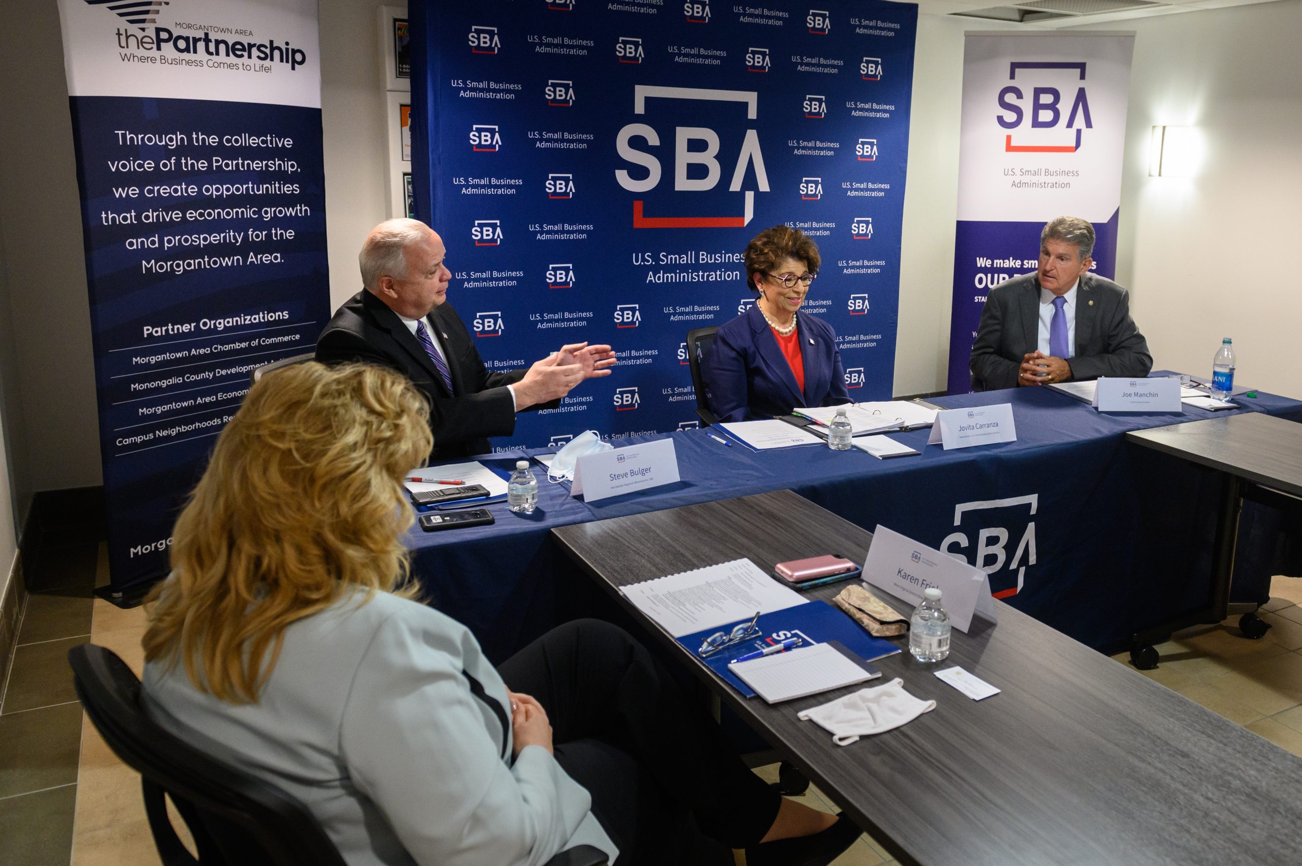 Jovita Carranza, the administrator of the Small Business Administration, center, and Sen. Joe Manchin, right, participate at a roundtable discussion at the Morgantown Area Economic Partnership on Monday in Morgantown, West Virginia.