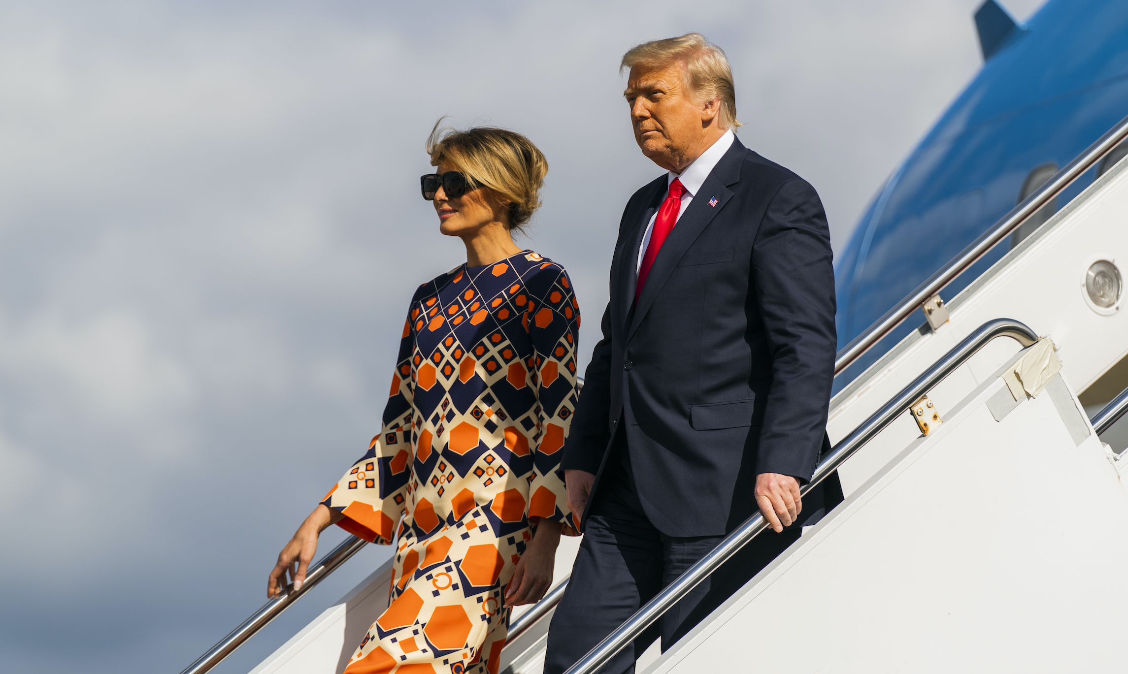 Former President Donald Trump and his wife Melania Trump disembark from their final flight on Air Force One at Palm Beach International Airport in West Palm Beach, Florida, on Wednesday.
