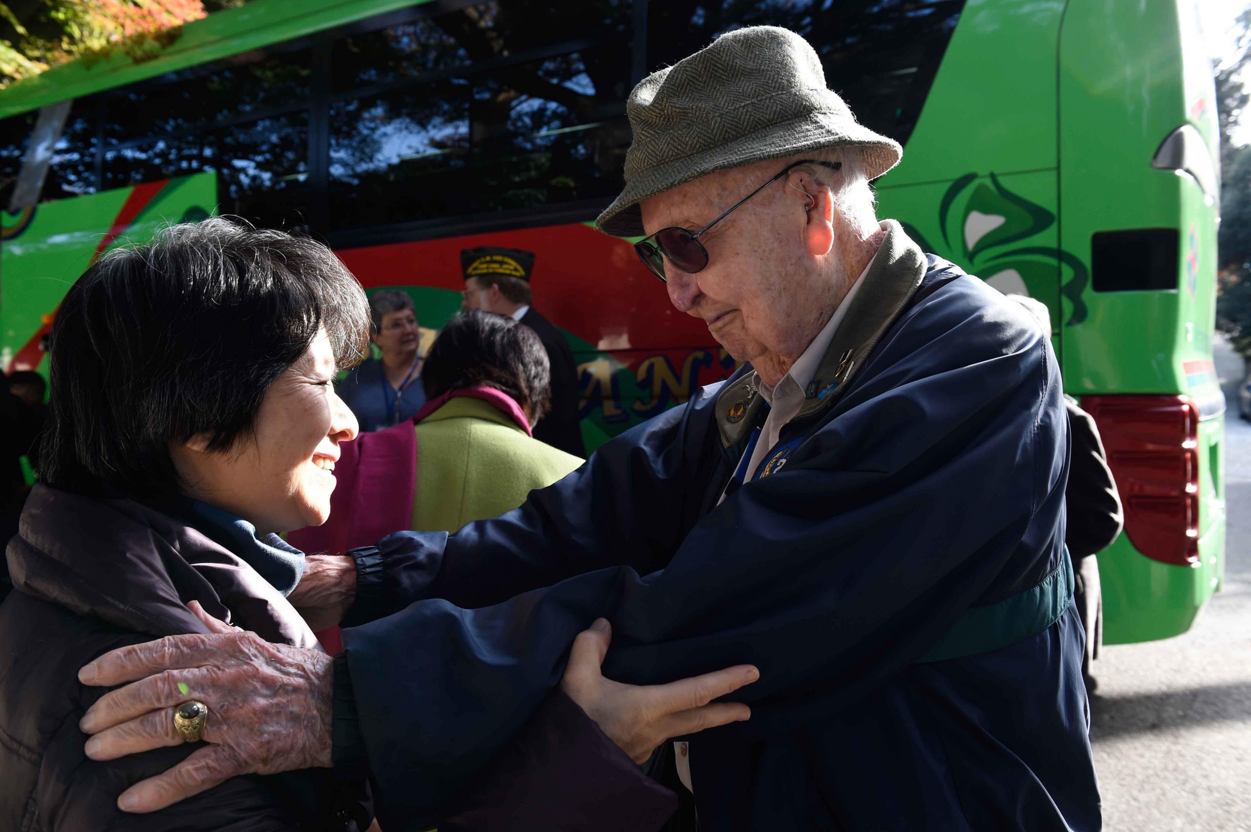 151207-N-IE405-265 HODOGAYA, Japan (Dec. 7, 2015) A Japanese woman embraces former prisoner of war Fiske Hanley at the sixth annual Japanese/ POW(s) Friendship Program. The Japanese government sponsored several former U.S. POWs' trip to Japan as a peacefu