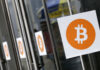In this 2014 photo, Bitcoin logos are displayed at the Inside Bitcoins conference and trade show in New York. Because of how cryptocurrencies like Bitcoin are mined, they have unique digital identities. And that design is something law enforcement and regulators can exploit to identify people using cryptocurrencies to hide illegal activity. (AP Photo/Mark Lennihan, File)