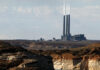 FILE - This Sept. 4, 2011, file photo shows the main plant facility at the Navajo Generating Station, as seen from Lake Powell in Page, Ariz. The federal government has come up with a final version of a rule meant to cut haze-causing emissions from the largest coal-fired power plant in the West. The U.S. Environmental Protection Agency's decision Monday, July 28, 2014, reflects a compromise by tribal and federal officials, environmental groups and the owners of the Navajo Generating Station, which is on track to cease operations in 2044. (AP Photo/Ross D. Franklin, File)