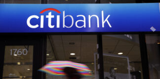 In this Jan. 14, 2014, file photo, a person walks past a Citibank location in Philadelphia. 