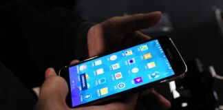 The new Samsung Galaxy S5 is examined by a visitor to the Mobile World Congress, the world's largest mobile phone trade show in Barcelona, Spain, Monday, Feb. 24, 2014, after its unveiling. (AP Photo/Manu Fernandez)