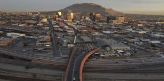 FILE - Cars line up at the Paso del Norte international bridge in Ciudad Juarez, Mexico, below, on the border with El Paso, Texas, top, Nov. 8, 2021. (AP Photo/Christian Chavez, File)