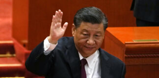 Chinese President Xi Jinping attends a commendation ceremony for role models of the Beijing Winter Olympics and Paralympics at the Great Hall of the People Friday, April 8, 2022, in Beijing. 