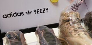 A sign advertises Yeezy shoes made by Adidas at Kickclusive, a sneaker resale store, in Paramus, New Jersey.