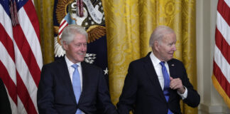 President Joe Biden and former President Bill Clinton listen as Vice President Kamala Harris speaks during an event in the East Room of the White House in Washington. (AP Photo/Susan Walsh)