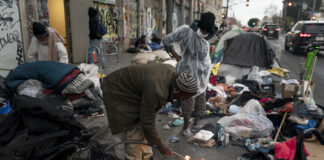 Robert Mason, a 56-year-old homeless man, warms up a piece of doughnut over a bonfire he set to keep himself warm on Skid Row in Los Angeles, on Feb. 14, 2023. Homeless people in California are already a vulnerable group, often struggling with poor health, trauma and deep poverty before they lose their housing, according to a new study on adult homelessness released Tuesday, June 20, by the University of California, San Francisco, aimed at capturing a comprehensive picture of how people become homeless in California. 