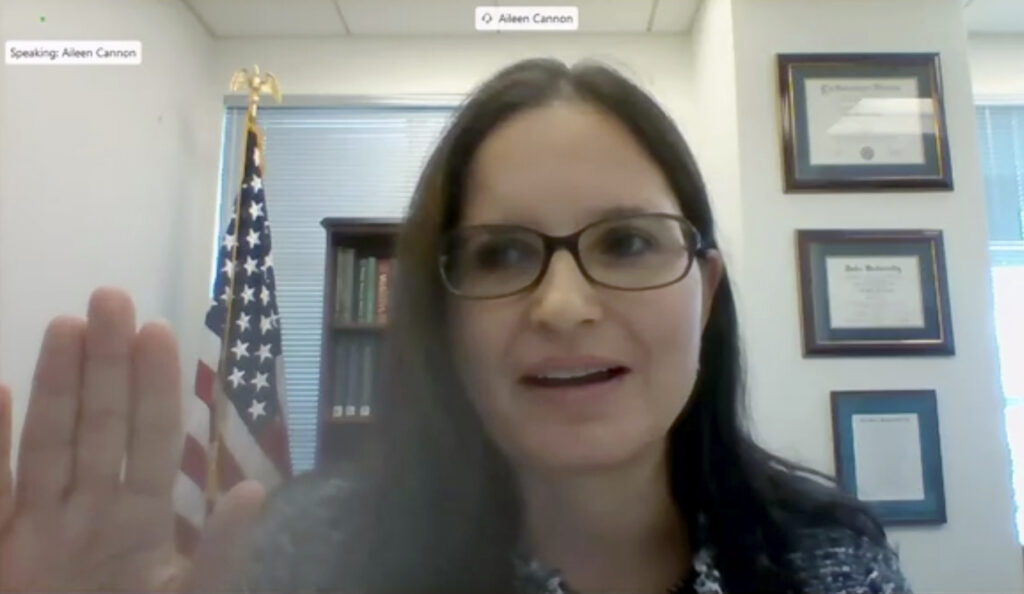 In this image from video provided by the U.S. Senate, Aileen M. Cannon raises her hand after being sworn in to testify remotely during a Senate Judiciary Committee oversight nomination hearing to be U.S. District Court for the Southern District of Florida on July 29, 2020, in Washington.