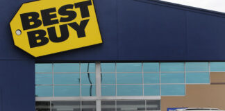 FILE - A woman walks with a boy to the Best Buy store at the Mall of New Hampshire, Tuesday, Aug. 4, 2020, in Manchester, N.H.  Best Buy sales and profits slid in the second quarter, Tuesday, Aug. 29, 2023. (AP Photo/Charles Krupa, File)
