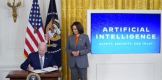 President Joe Biden signs an executive on artificial intelligence in the East Room of the White House, Monday, Oct. 30, 2023, in Washington as Vice President Kamala Harris looks on.