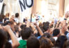 Rearview shot of a crowd protesting outside a public building