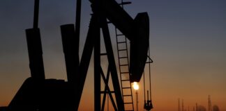 An oil pump works at sunset on Jan. 18, 2016, in the desert oil fields of Sakhir, Bahrain.