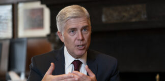 Associate Justice Neil Gorsuch, President Donald Trump's first appointee to the high court, speaks to The Associated Press about events that have influenced his life and the loss of civility in public discourse, in his chambers at the Supreme Court in Washington, Wednesday, Sept. 4, 2019.