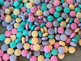 The image shows fentanyl pills in multiple colors, which the DEA says is an intentional move by the drug cartels to make them "look like candy."