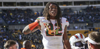 Miami defensive back Sheldrick Redwine (22) shows off their "U" turnover chain after recovering a fumble against Pittsburgh in an NCAA college football game, Friday, Nov. 24, 2017, in Pittsburgh.
