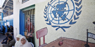 Palestinian refugees attend a protest demanding resumption of food distribution to the refugees, outside the offices of the United Nations Relief and Works Agency (UNRWA), in Gaza City, Monday, April 15, 2013. The UNRWA has halted rations and monthly cash allocated for poor families of Palestinian refugees which from April 1 due to budget cuts.