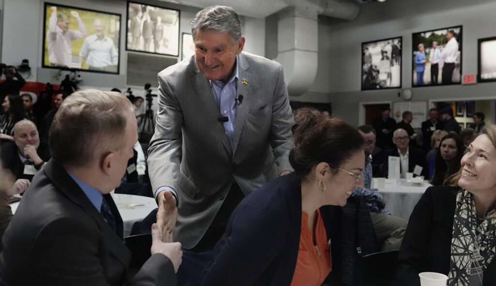 Sen. Joe Manchin (D-WV) shakes hands with a New Hampshire resident at the 'Politics and Eggs' event, Friday, Jan. 12, 2024.