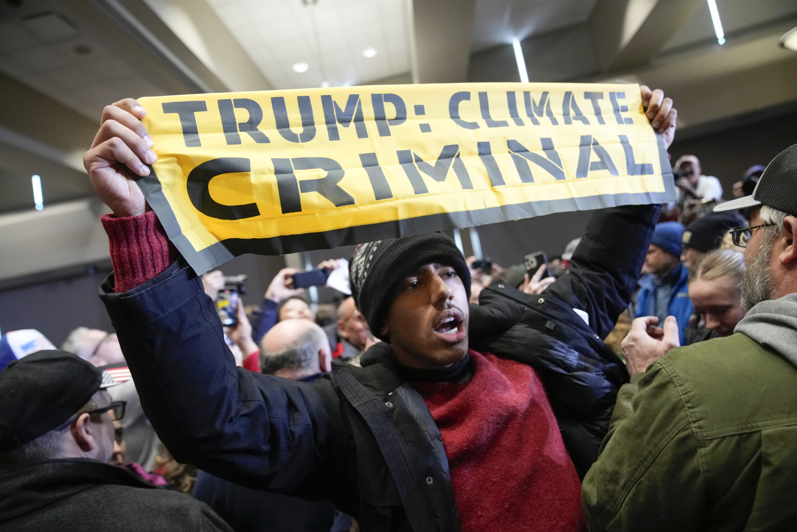 NextImg:Trump's final rally before Iowa caucuses interrupted by climate protesters