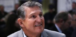 Sen. Joe Manchin (D-WV) smiles while being introduced during an event on Friday, Jan. 12, 2024, in Manchester, N.H. (AP Photo/Charles Krupa)