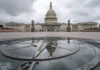 The U.S. Capitol Dome is reflected in a rain puddle on the compass star on the east side of the building, Sunday, Sept. 24, 2023. (AP Photo/J. David Ake)