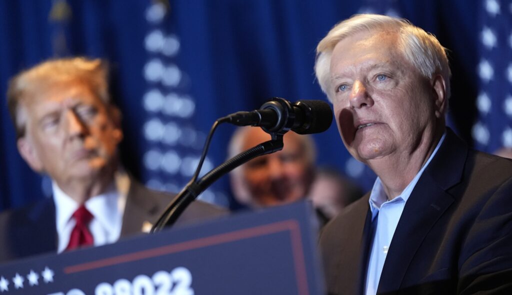 Sen. Lindsey Graham (R-SC) speaks as Republican presidential candidate former President Donald Trump listens at a primary election night party at the South Carolina State Fairgrounds in Columbia, S.C., Saturday, Feb. 24, 2024. (AP Photo/Andrew Harnik)